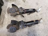 two brushes that are laying on the ground