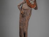 an image of a statue of a man holding a cat on his back