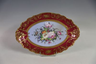 une assiette rouge et dorée ornée de fleurs