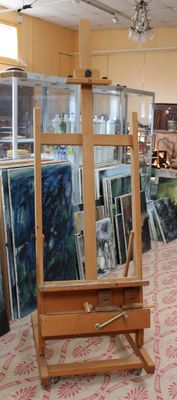 a room filled with art supplies and paintings on display
