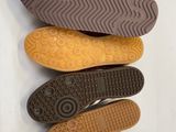 three pairs of shoes are lined up on a white surface