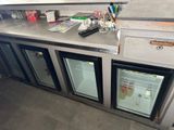 a counter that has a bunch of bottles on top of it