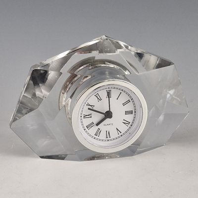 a glass clock with roman numerals on the face
