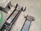 some tools are laying out on the floor in a garage