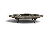an antique silver plate on a stand on a white background