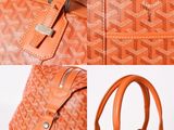an image of an orange handbag with a zipper on it