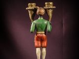 statue of a man holding two cups on his head