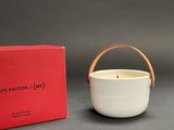 an image of a white candle with a red box in the background