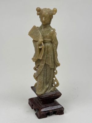 une image représentant une statue d'une femme tenant un éventail