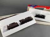 two model trains sitting in a box on a table