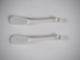 three white spoons sitting on a white surface