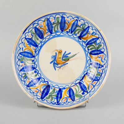 an image of a blue and white plate with a bird on it