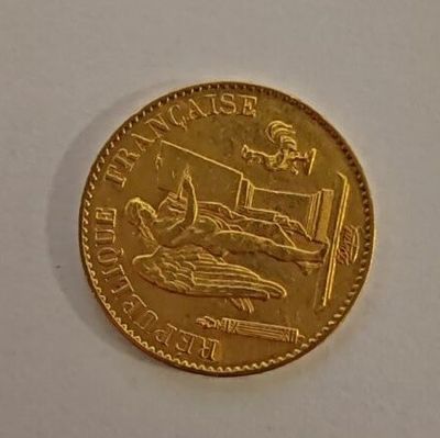 a gold coin with a picture of a man in bed on it