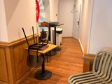 a room with several chairs and a table in it