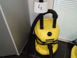 a yellow vacuum sitting on the floor next to a yellow bucket