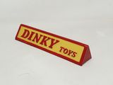 a red and yellow sign that says dinky toys