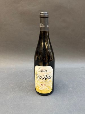 an empty bottle of wine sitting on a table