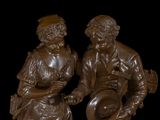 statue of a man and a woman sitting on a bench
