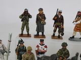 many figurines of soldiers that are standing on a table