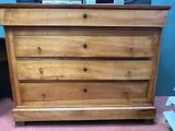 a wooden chest of drawers on a pink carpeted floor