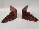 two wooden bookends with a train design on them