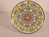 a decorative plate with a blue and yellow design on it