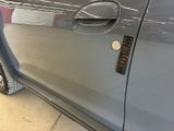 a close up of a car door handle with a sticker on it