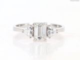 a close up view of a three stone engagement ring