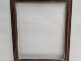 a wooden picture frame with a white background