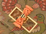 a small toy skateboard with orange wheels on a rug