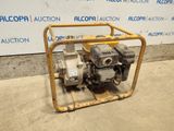 a close up of a small engine on a cart in front of a wall
