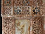 a marble panel with carvings on it in a room