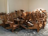 a pile of wooden chairs sitting in a room