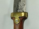 a close up of a knife with a wooden handle