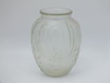 a glass vase that is sitting on a white surface