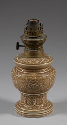 pair of antique brass lamps on pedestals on a gray background