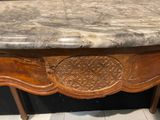 a marble top table with a carved design on it
