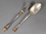 two silver spoons and a fork on a gray surface