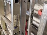 a close up of a metal ladder with a red handle