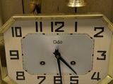 a small clock with a bell on top of it