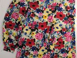 a yellow and red floral shirt with a black and white flower print