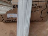 a cardboard box with a bunch of white plastic straws in it