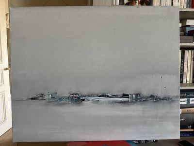 a painting that is sitting on a table in front of a bookshelf
