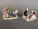 two figurines of people riding on horses and a horse drawn carriage