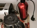 a coffee pot and a toaster sitting on a kitchen counter