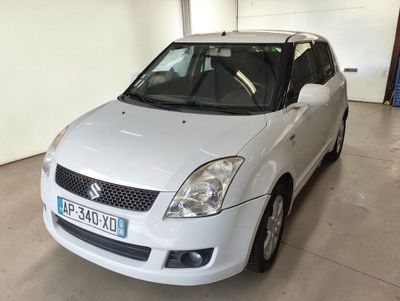 a small white car parked in a garage