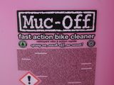 the container is pink and has a sticker on it that says muc off