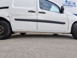 a white van parked in front of a building