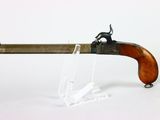 an old gun with a wooden handle on a white surface