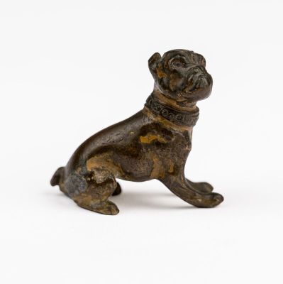a bronze statue of a dog with a collar on it ' s neck